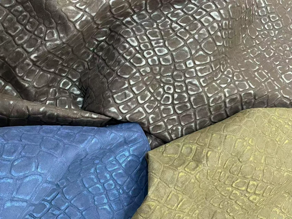 KS-37430: A raised, irregular scale pattern with a reflective surface. The supplied photograph shows contrasting colourways.