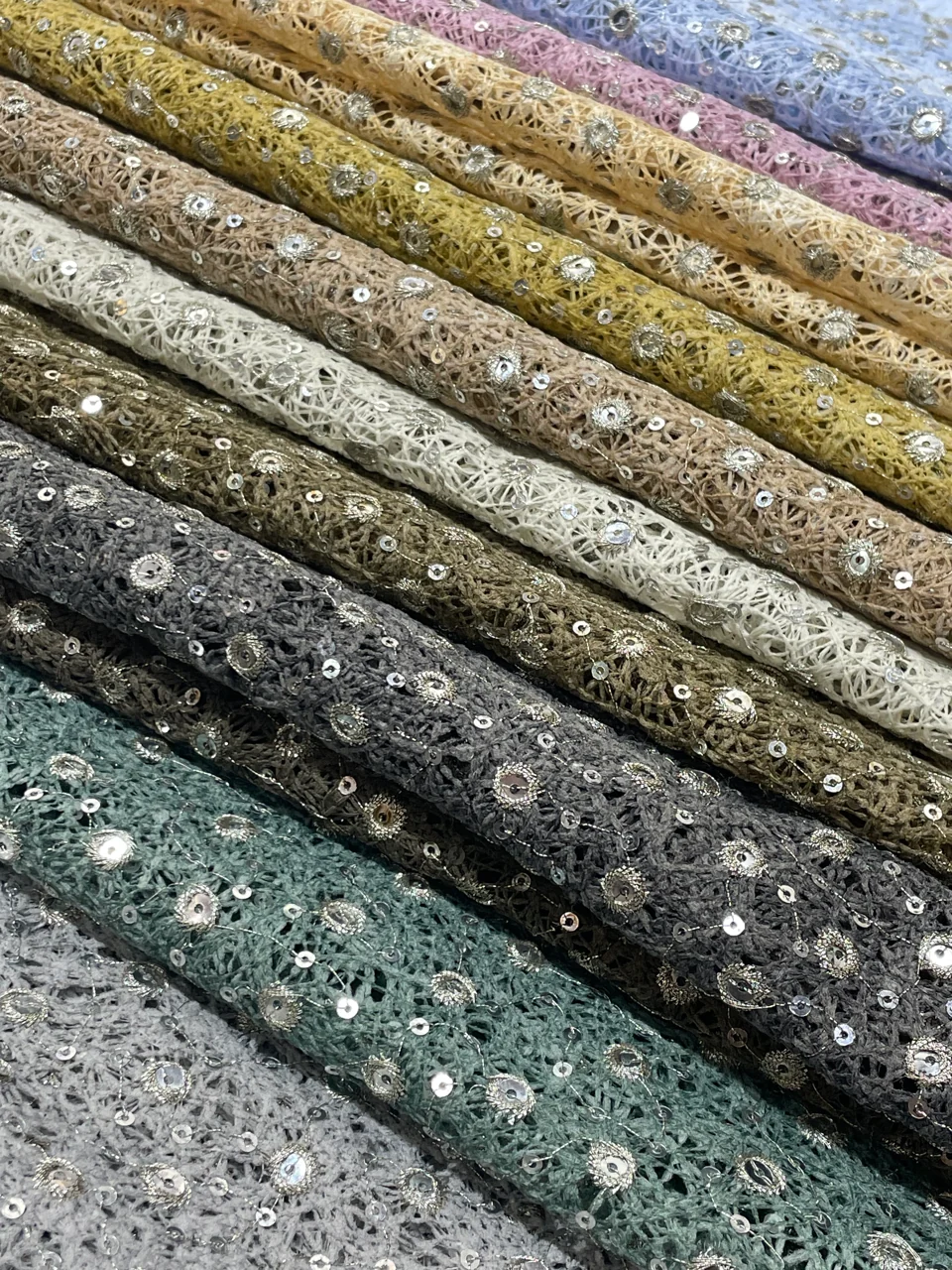 KS-39920: An open textured structure dotted with small reflective details. The supplied photograph shows a range of tones.
